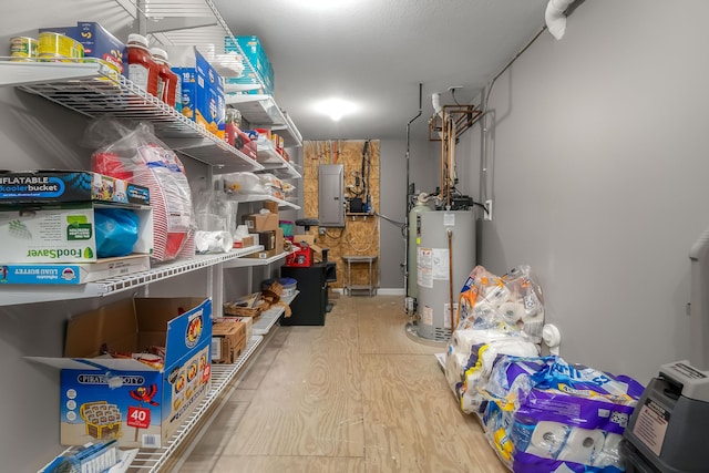 storage area featuring water heater and electric panel