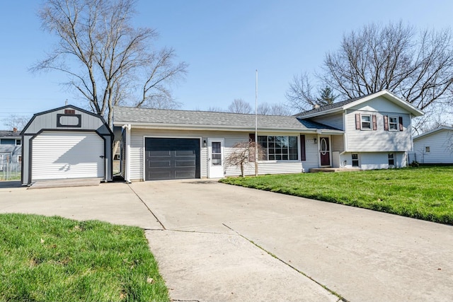 1373 Kingman Dr, Saint Joseph, MI 49085 - split level home featuring a shingled roof, a garage, concrete driveway, and a front yard