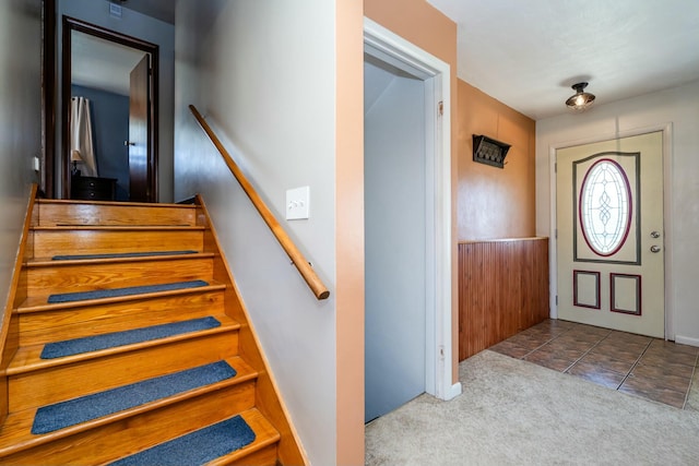 1373 Kingman Dr, Saint Joseph, MI 49085 - carpeted foyer with stairs and tile patterned flooring