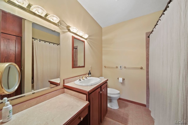 bathroom with vanity, toilet, tile patterned floors, baseboards, and curtained shower