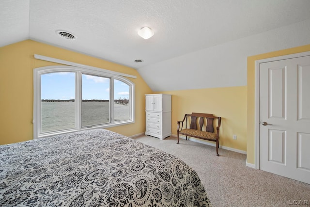 bedroom with carpet floors, baseboards, visible vents, and lofted ceiling