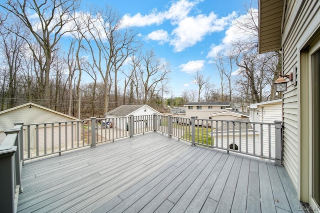wooden deck with a residential view and an outdoor structure