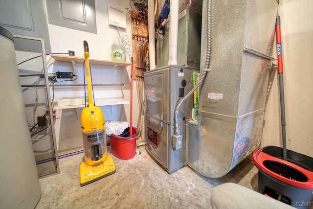 utility room with heating unit and electric panel