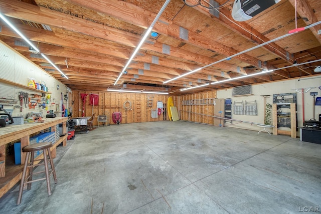 garage featuring a workshop area and a garage door opener
