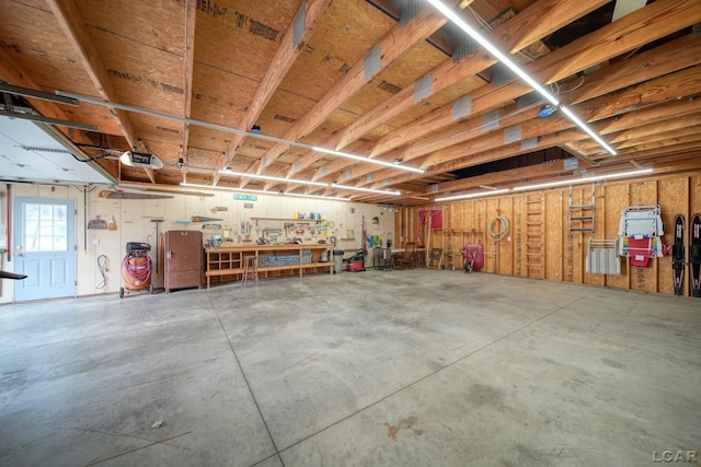 garage with a garage door opener and a workshop area