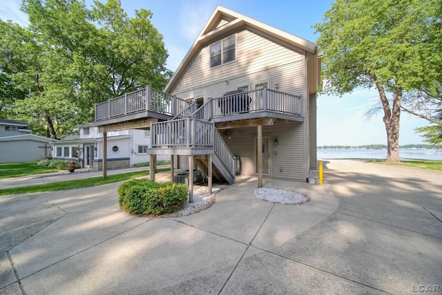 3387 Round Lake Hwy, Manitou Beach, MI 49253 - back of house featuring a deck with water view and stairway