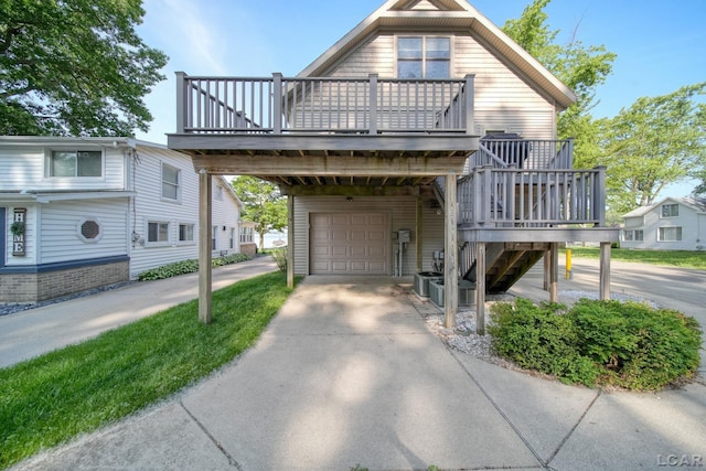 3387 Round Lake Hwy, Manitou Beach, MI 49253 - view of front of property with driveway, a deck, stairway, and a detached garage
