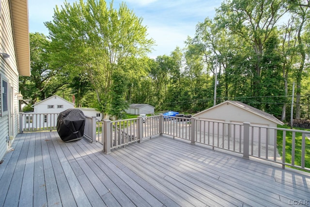 3387 Round Lake Hwy, Manitou Beach, MI 49253 - wooden terrace featuring a grill, view of wooded area, and a storage shed