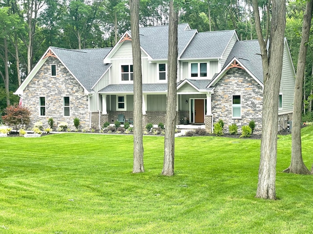 2323 Canterwood, Highland, MI 48357 - craftsman house featuring a shingled roof, a front lawn, and board and batten siding
