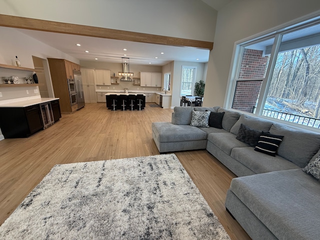 2323 Canterwood, Highland, MI 48357 - living room featuring vaulted ceiling, light wood-type flooring, and recessed lighting
