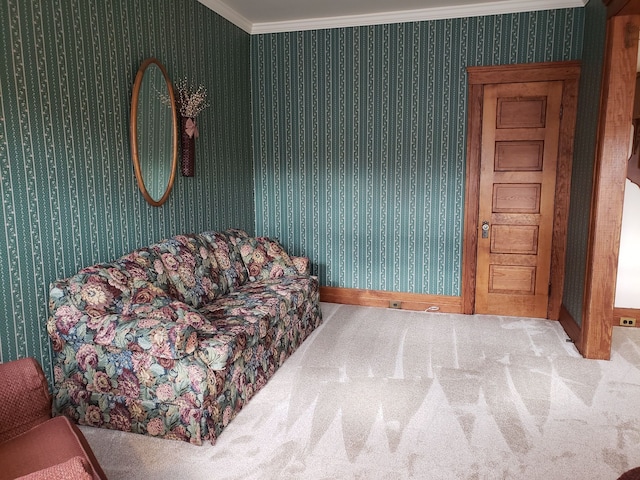 sitting room featuring wallpapered walls, crown molding, carpet, and baseboards