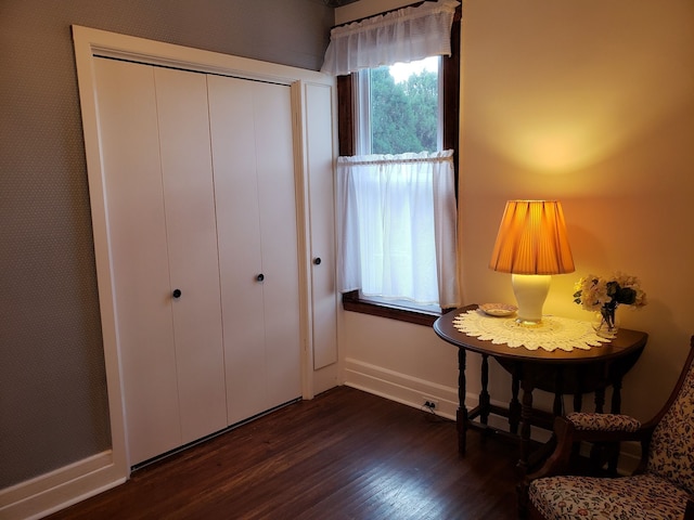 unfurnished room with dark wood-style floors and baseboards