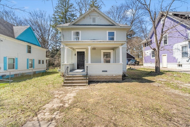 1026 S Jackson St, Jackson, MI 49203 - american foursquare style home with a front yard, a porch, and fence