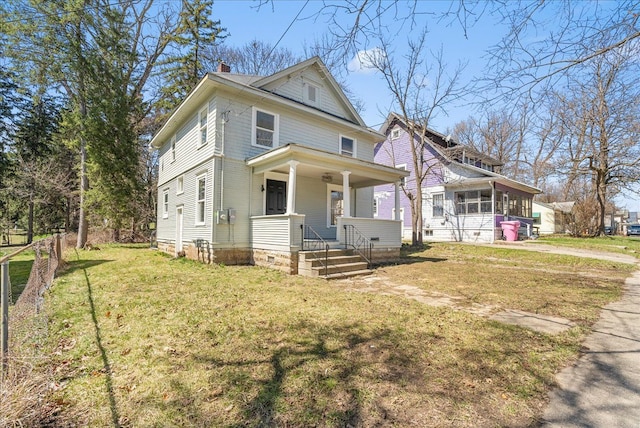 1026 S Jackson St, Jackson, MI 49203 - american foursquare style home with a chimney, a front lawn, a sunroom, and a porch