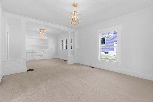 1026 S Jackson St, Jackson, MI 49203 - spare room with an inviting chandelier, baseboards, visible vents, and carpet floors