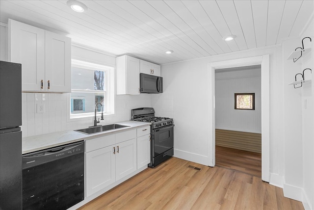 1026 S Jackson St, Jackson, MI 49203 - kitchen with visible vents, wooden ceiling, a sink, black appliances, and white cabinetry