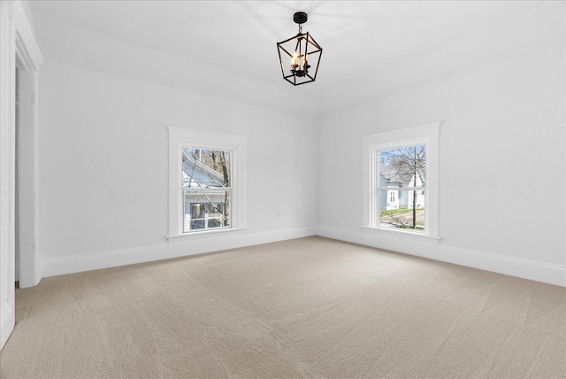 1026 S Jackson St, Jackson, MI 49203 - interior space with carpet flooring, baseboards, and an inviting chandelier