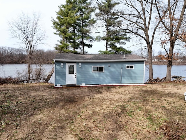 rear view of property with entry steps and a water view