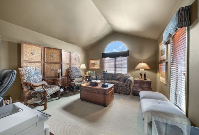 carpeted living area featuring a healthy amount of sunlight and lofted ceiling