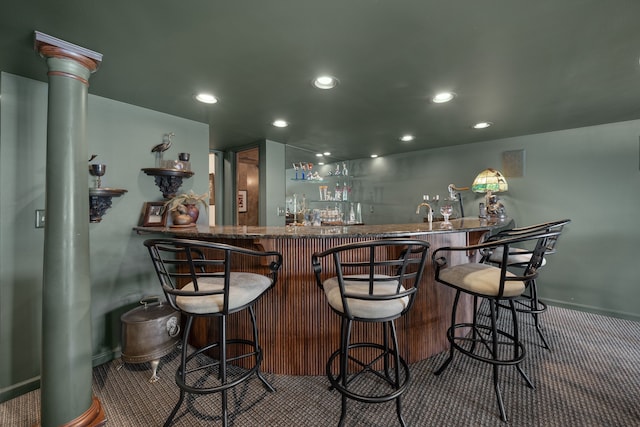 bar with decorative columns, baseboards, recessed lighting, carpet flooring, and wet bar
