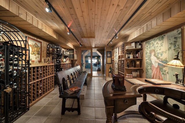 wine cellar with rail lighting, tile patterned floors, and wooden ceiling