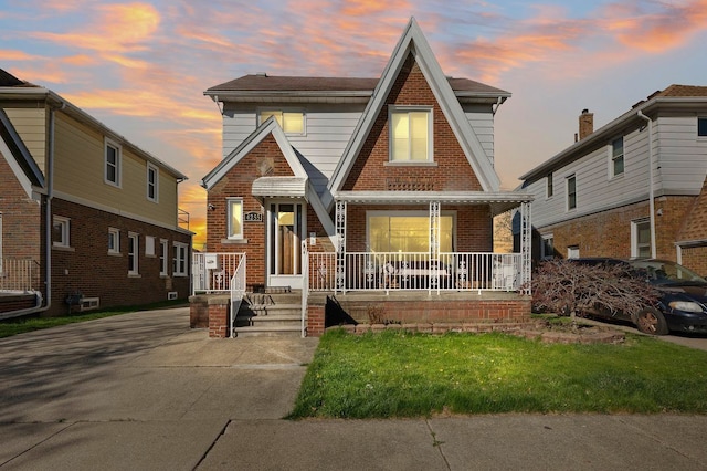 view of front of property with a porch and brick siding