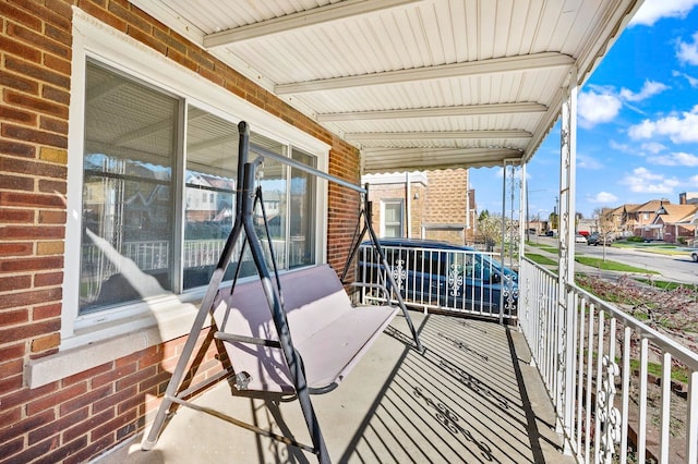 balcony with covered porch and a residential view