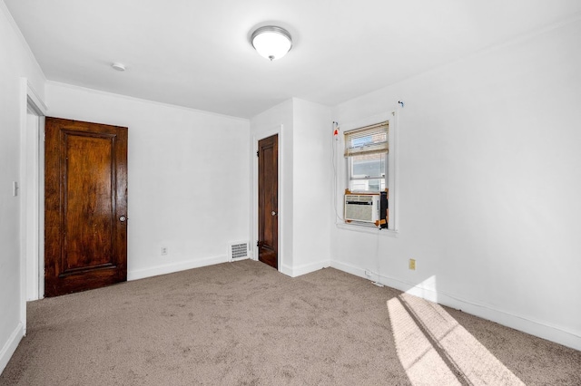 unfurnished bedroom featuring visible vents, carpet, and baseboards