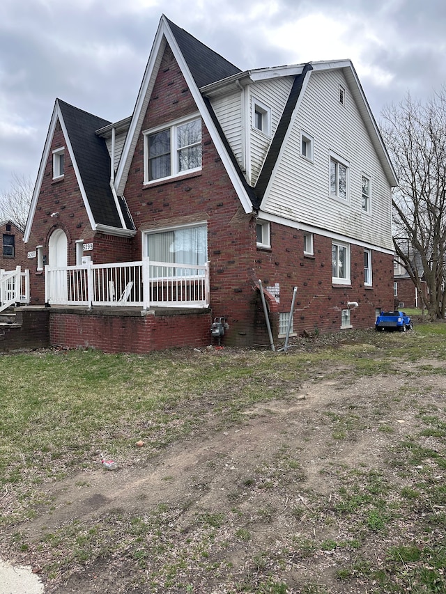 rear view of property with brick siding