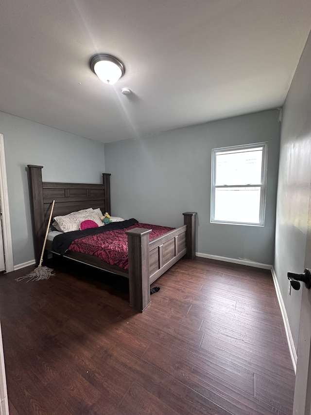 bedroom featuring baseboards and wood finished floors
