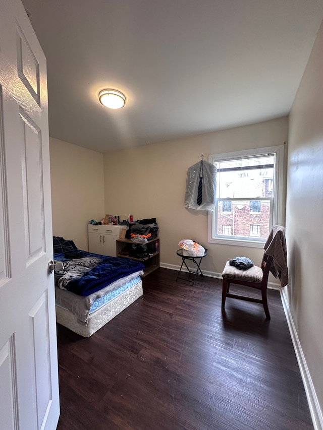 bedroom featuring baseboards and wood finished floors