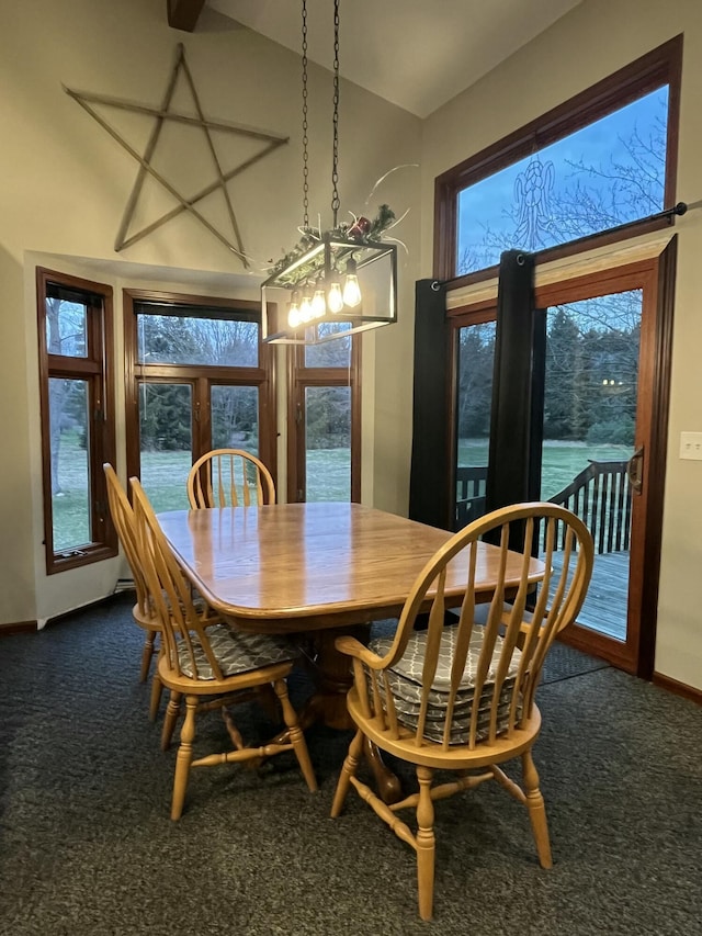 9610 Grange Ave NE, Rockford, MI 49341 - dining room featuring carpet floors, baseboards, vaulted ceiling, and a wealth of natural light