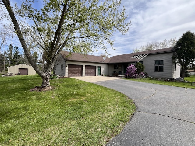 9610 Grange Ave NE, Rockford, MI 49341 - ranch-style home with a garage, a front lawn, and driveway