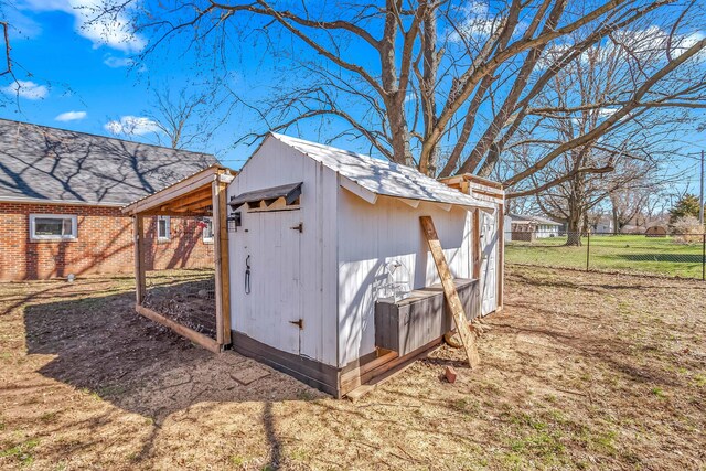 view of shed featuring fence