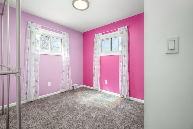 unfurnished room featuring carpet flooring, baseboards, and visible vents