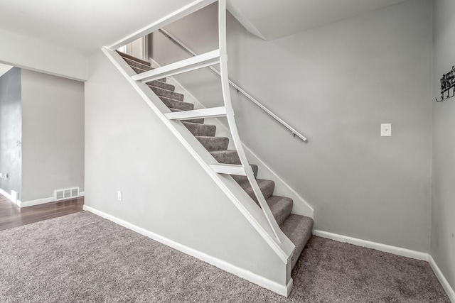 staircase with carpet, baseboards, and visible vents