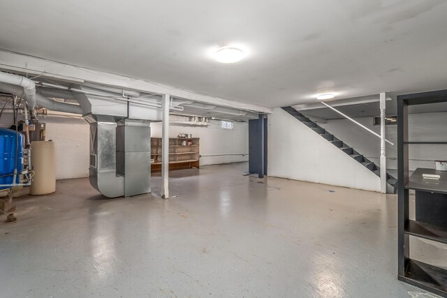 below grade area featuring heating unit and stairway