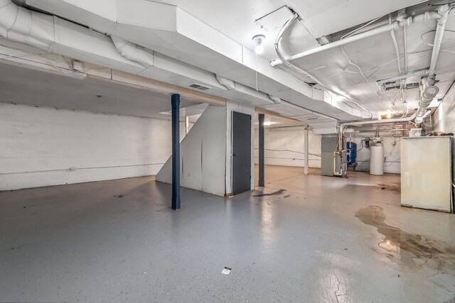 unfinished below grade area with heating unit and visible vents