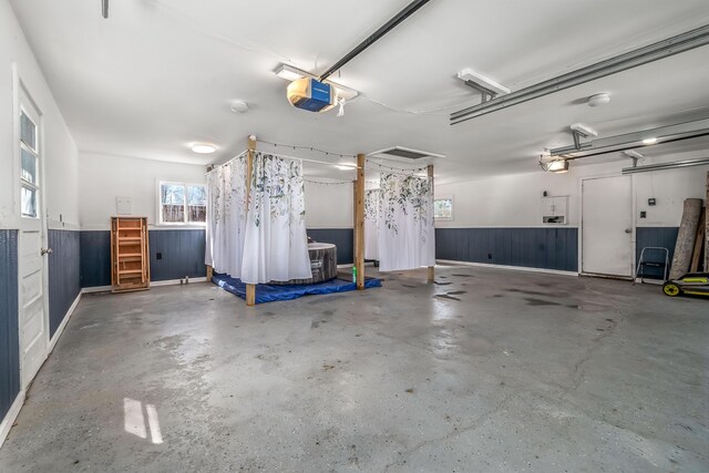 garage featuring a garage door opener and wainscoting