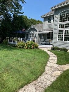 back of property featuring a lawn