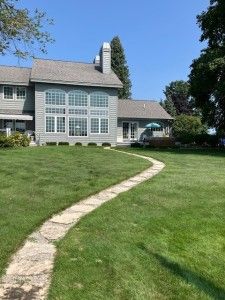 back of property featuring a chimney and a yard