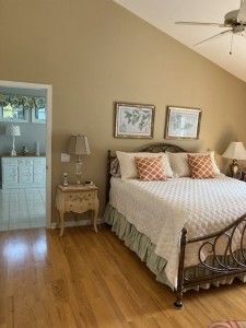 bedroom featuring high vaulted ceiling, wood finished floors, and a ceiling fan