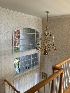 interior details with a chandelier and crown molding