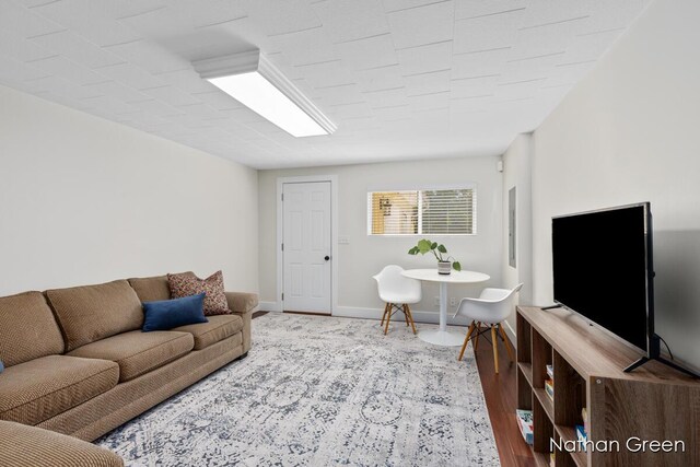 living room featuring baseboards and wood finished floors