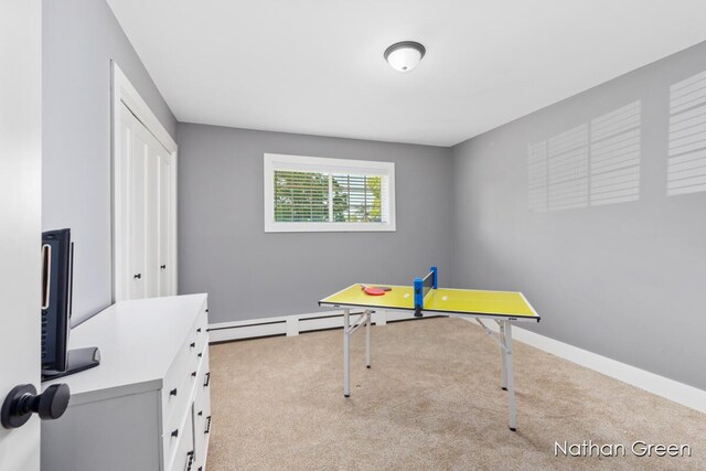 playroom with a baseboard radiator, carpet floors, and baseboards