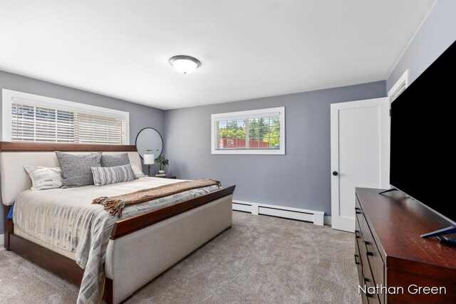 bedroom featuring carpet floors and a baseboard heating unit