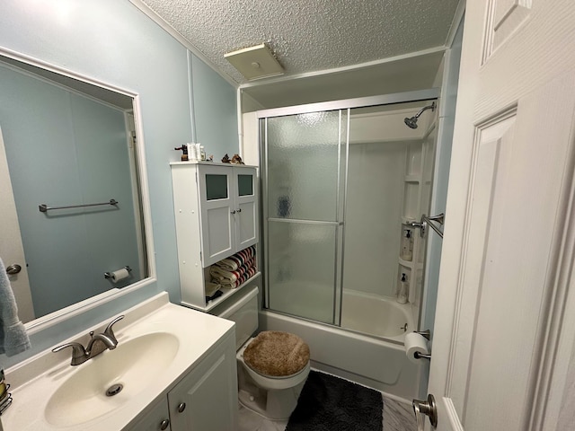 full bathroom featuring shower / bath combination with glass door, toilet, vanity, and a textured ceiling