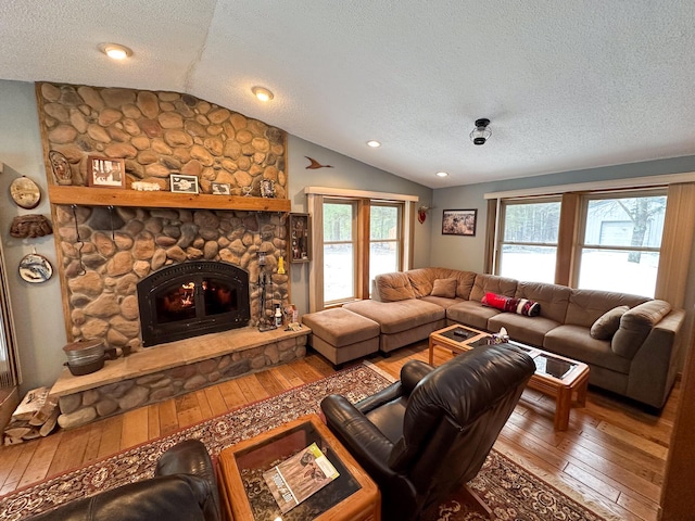 living area featuring a wealth of natural light, lofted ceiling, and wood-type flooring