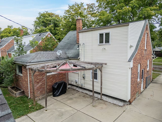 4423 Groveland Ave, Royal Oak, MI 48073 - back of property featuring a patio, brick siding, and a chimney