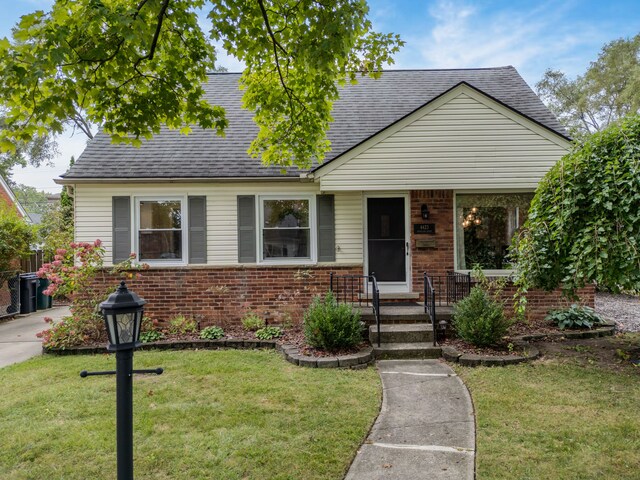 4423 Groveland Ave, Royal Oak, MI 48073 - view of front of home with roof with shingles, a front yard, and brick siding